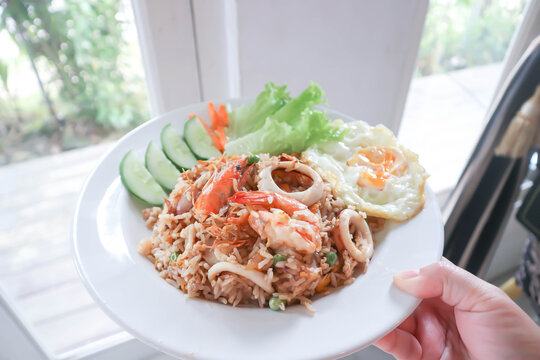 fried rice or stir-fried rice with shrimp , squid and fried egg or sunny side up egg