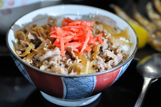 stir fried beef with vegetable and rice or Rice topped with stir fried pork or stir fried beef or Japanese food or Korean food or Beef Rice Bowl , Gyudon