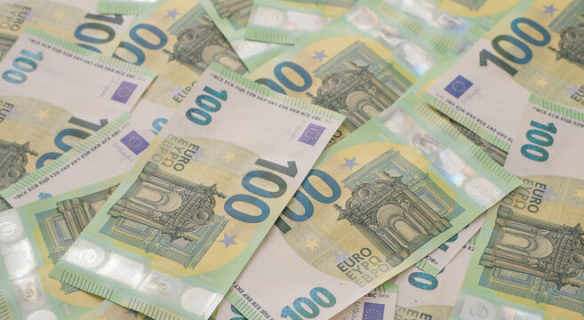 Cash background with many green 100 Euro currency notes 