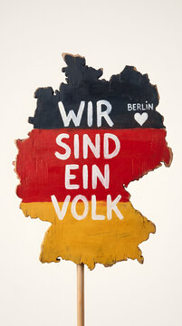 German Unity Day sign with map cutout and Wir sind ein Volk text