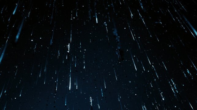 Abstract streaks of light on a dark blue background resembling falling stars or rain