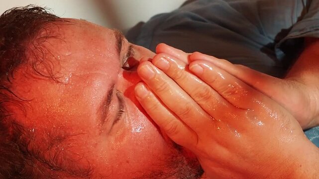 A man suffers while lying in the bathtub late at night