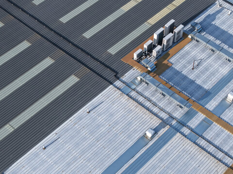 Melbourne, VIC, Australia - 22 September 2026: Aerial view of industrial factory rooftops in Kilsyth featuring corrugated metal surfaces and multiple HVAC units.