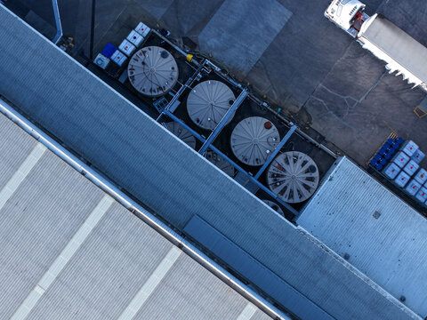 Melbourne, VIC, Australia - 22 September 2026: Aerial view of industrial facility in Kilsyth with circular storage tanks and a truck in the loading area.