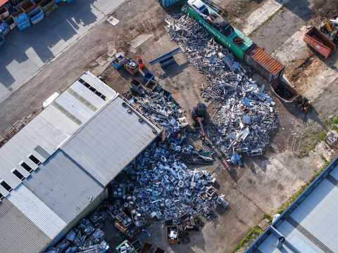 Melbourne, VIC, Australia - 22 September 2026: Aerial view of industrial scrap metal recycling facility in Kilsyth with piles of metal, shipping containers, and factory buildings.