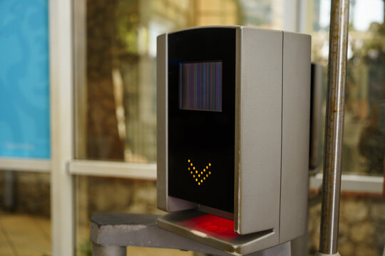 Electronic ticket validator device for public transit with a screen showing a screen glitch, used for gate access control and fare validation