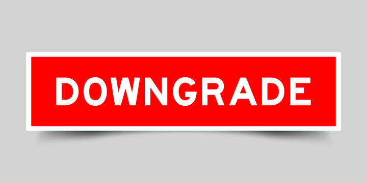 Red color square shape sticker label with word downgrade on gray background