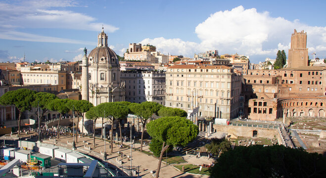 Trajan's Forum and Trajan's Market in Rome, Italy, with the dome of Santissimo Nome di Maria al Foro Traiano Church and the green canopy of pine trees