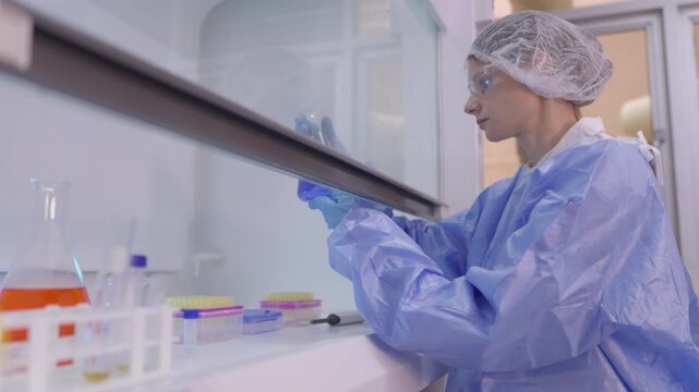 Woman medic works in bacteriological laboratory