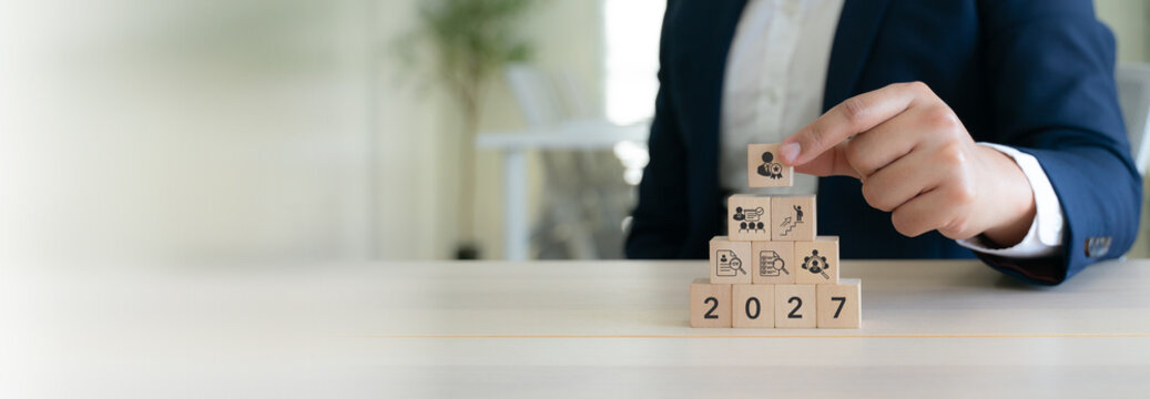 2027 Talent Acquisition Planning. Building recruitment strategy concept with wooden blocks with resume screening, candidate evaluation, employee selection, career advancement and talent management.