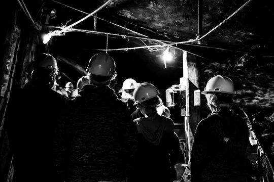 Selective focus on anthracite coal on a conveyer belt with defocused group in the Lackawanna Coal Mine Tour at McDade Park.