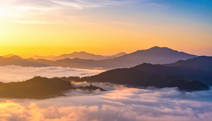 Fototapeta premium Golden sunrise illuminating misty mountain peaks and valleys at dawn, creating a serene natural vista