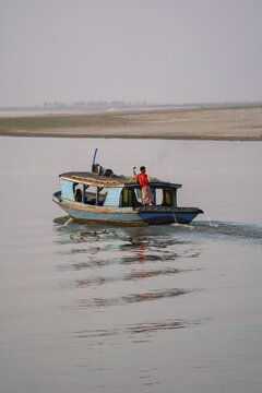Boat with people goes on Irrawaddy River, Mingun, Myanmar