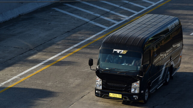 High angle shot of a black Isuzu Elf microbus