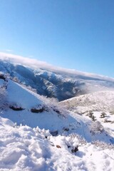 Obraz premium Snow Covered Mountain Landscape in Morocco with Blue Sky and Frosty Trees
