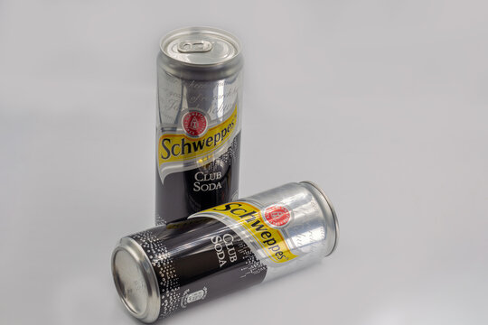 Schweppes Club Soda cans closeup on white.