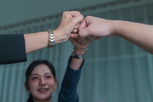 Two international businesswomen shaking hands, symbolizing a successful meeting or negotiation, reaching a mutual agreement, and signifying cooperation and the finalization of a deal or business partn