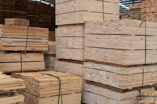 Stacks of wooden boards and wooden pallets in the warehouse