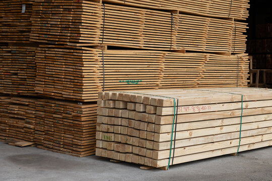 Stacks of wooden boards and wooden pallets in the warehouse