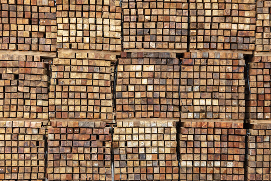 Stacks of wooden boards and wooden pallets in the warehouse