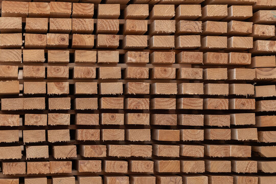 Stacks of wooden boards and wooden pallets in the warehouse
