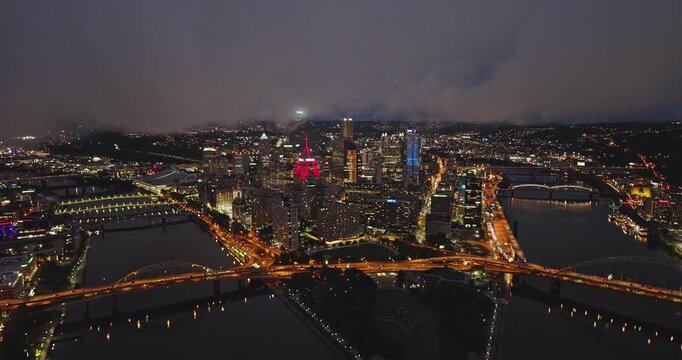 Pittsburgh Pennsylvania Aerial v34 flyover Ohio River capturing the vibrant downtown cityscape illuminated at dusk with low clouds covering the twilight sky - Shot with 8k Camera - Sept 24th 2023
