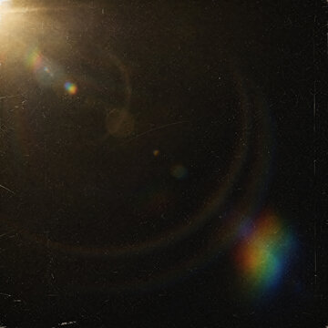 Abstract lens flare with light leaks on a dark textured background