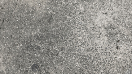 Top down view of a weathered grey concrete floor surface with rough texture and copy space © Abu Jor