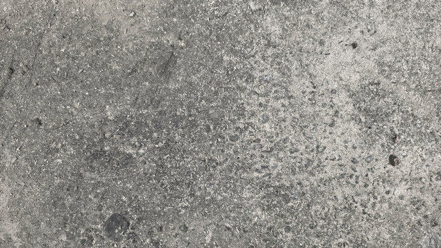 Top down view of a weathered grey concrete floor surface with rough texture and copy space