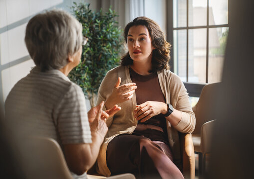 Therapist and Elderly Woman Having Supportive Conversation