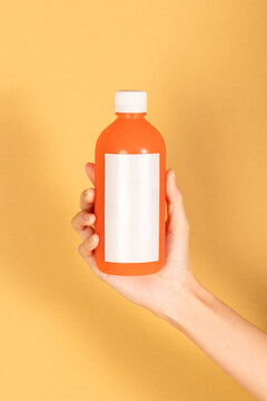 Hand holding vibrant juice bottle