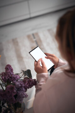 Woman using smartphone at home &ndash; online communication and digital lifestyle.