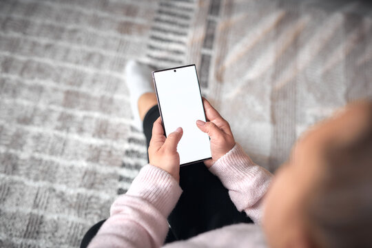 Woman using smartphone at home &ndash; online communication and digital lifestyle.
