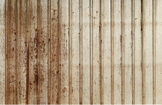 Texture or background of Rusted, aged galvanized sheet metal wall surface; weathered galvanized steel fence; retro concept; the artistry of old, rusty galvanized sheeting; vintage-style metal panels.