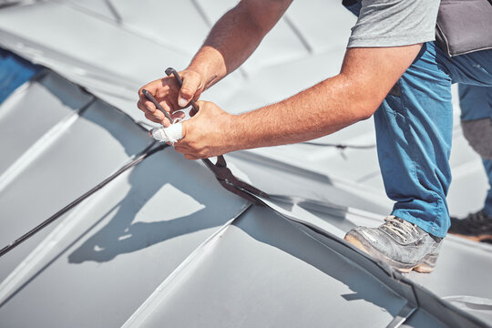 Roofer working on a roof replacement and reconstruction.