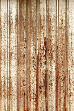 Texture or background of Rusted, aged galvanized sheet metal wall surface; weathered galvanized steel fence; retro concept; the artistry of old, rusty galvanized sheeting; vintage-style metal panels.
