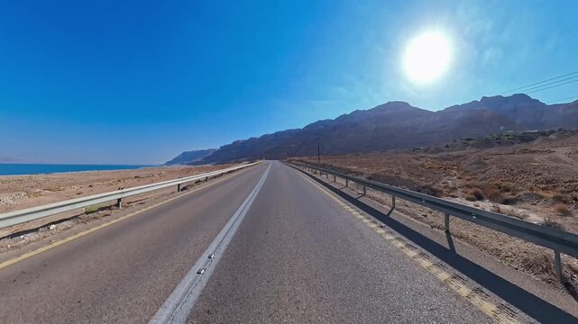 Driving along the Dead Sea road with scenic mountain view in sunny day, Israel