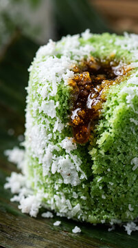 Traditional Indonesian green steamed cake with grated coconut and palm sugar filling.