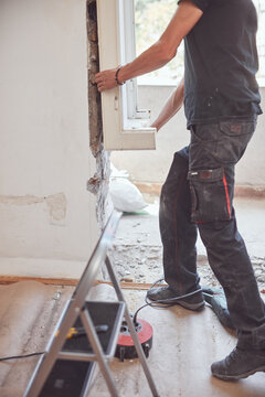 Workers changing old windows and doors in the apartment.