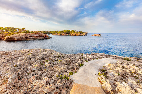 Concrete path across rocky coast in Cala d'Or, Mallorca, Spain.