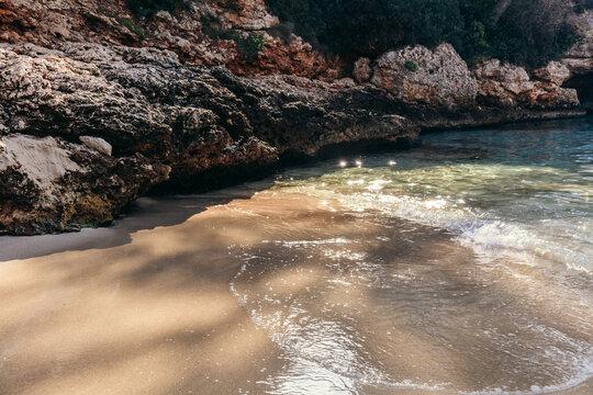 Cala Petita sandy cove in Mallorca, Spain with gentle surf.