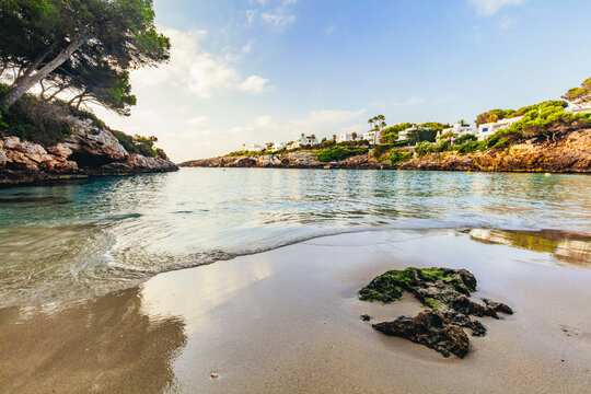 Sandy beach and calm water at Cala Esmeralda, Mallorca, Spain.