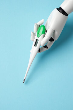 A white robotic hand holding a digital thermometer showing 38.0 degrees against a light blue background. Concept of AI in healthcare and medical diagnostics.