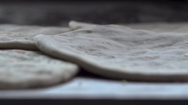 Close-up of raw flatbread ready to be cooked in a tandoor.