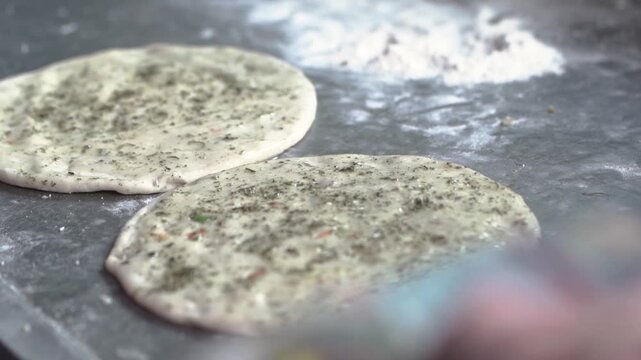 Close-up of raw flatbread ready to be cooked in a tandoor.