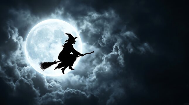 Witch silhouette flying on wooden broomstick across bright full moon during dark cloudy night sky