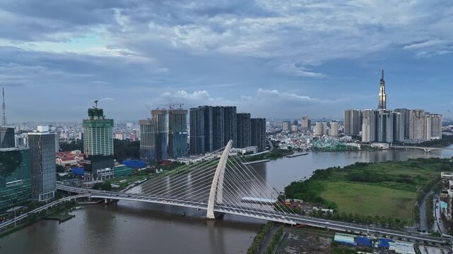 Aerial view of Ba Son Bridge over the Saigon River, surrounded by dense urban development and modern high-rise buildings in Ho Chi Minh City