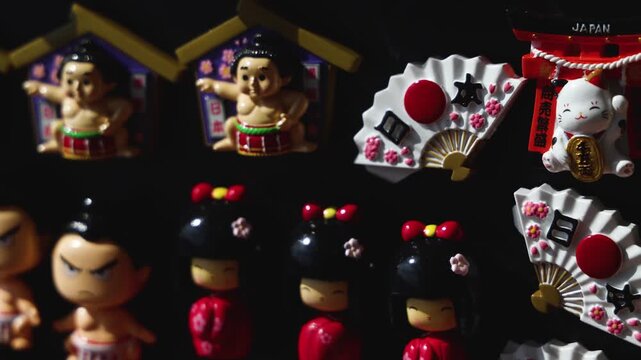 Japanese tourist souvenirs and gifts with symbols of Japan, daruma figure, kitsune fox, tengu mask, mount Fuji, fridge magnets, maneki-neko figurine, key ring keychain, local gift shop in Tokyo, Japan