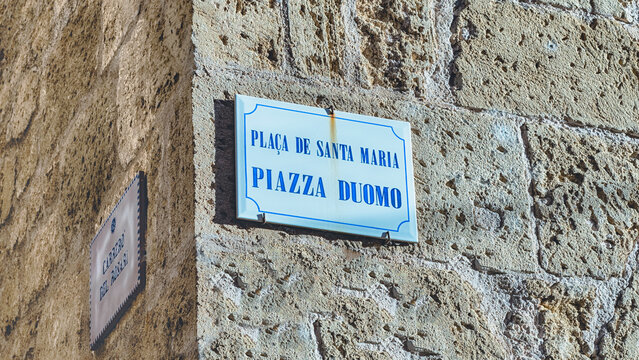 Cathedral square sign in Catalan and Italian language, Alghero, Italy