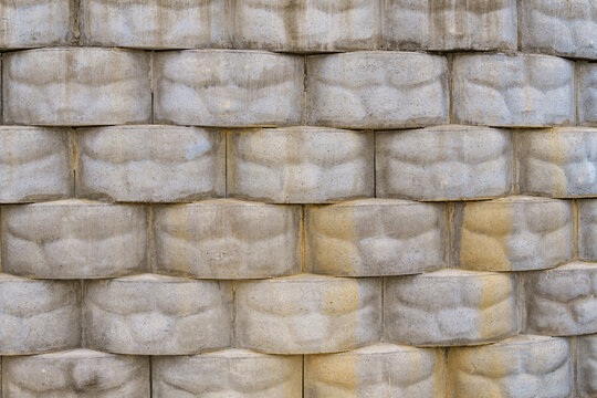 Texture of an interlocking modular concrete retaining wall.